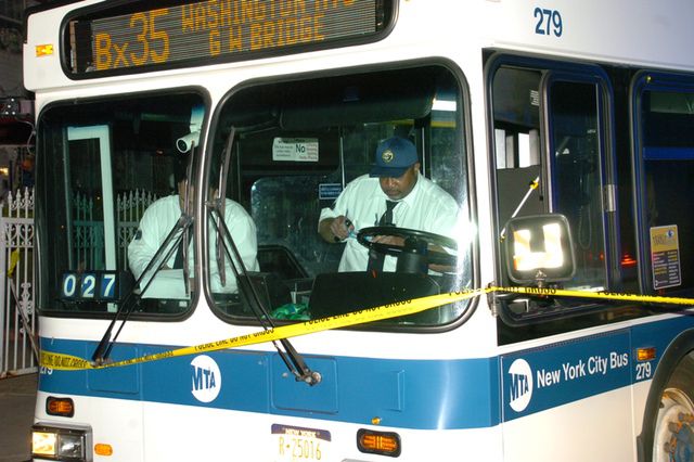 Investigators examine the Bx35 bus that sent a man to the hospital in critical condition on April 18.